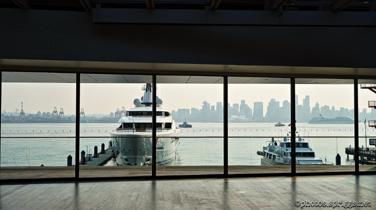 smoky day across the harbour with ostentatious wealth blighting the foreground vancouver skyline